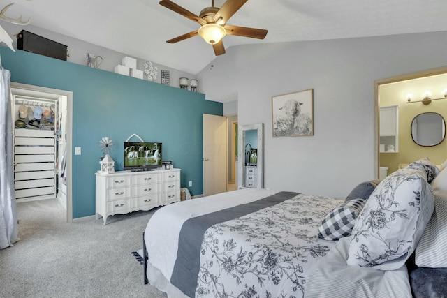 carpeted bedroom with ensuite bathroom, lofted ceiling, and ceiling fan