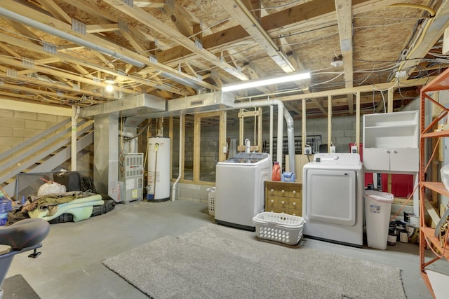 basement with water heater, washing machine and dryer, and heating unit