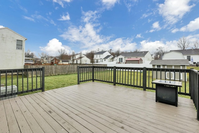 deck featuring a yard and an outdoor fire pit