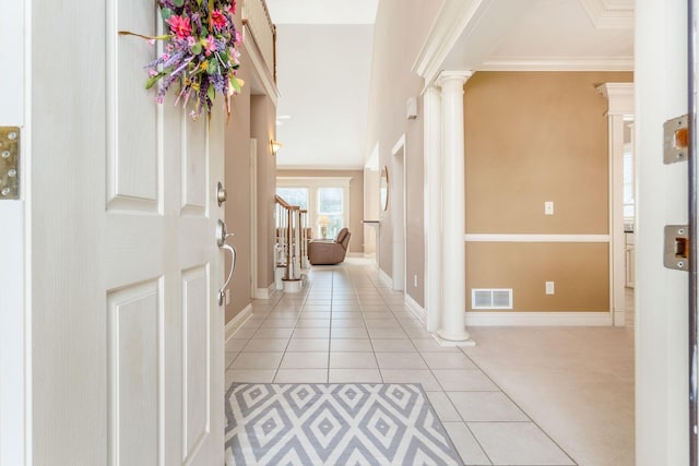 interior space with ornamental molding, visible vents, decorative columns, and light tile patterned floors