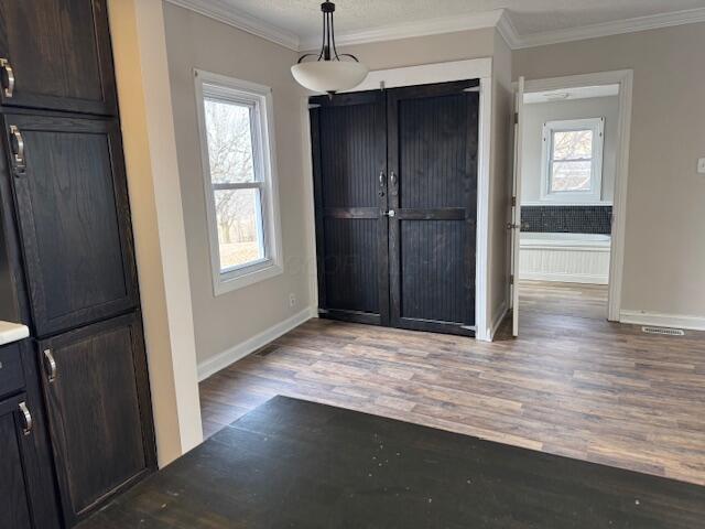 entrance foyer with ornamental molding and wood-type flooring