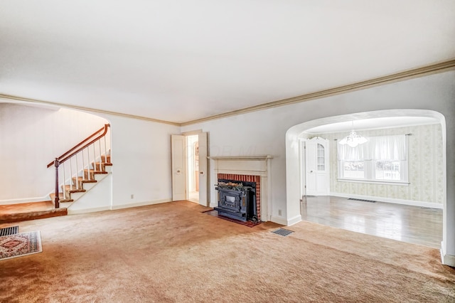 unfurnished living room featuring crown molding and carpet