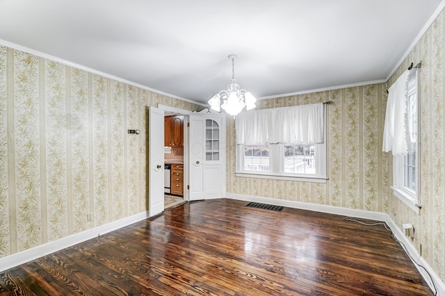 unfurnished dining area featuring crown molding, dark wood-type flooring, and a notable chandelier