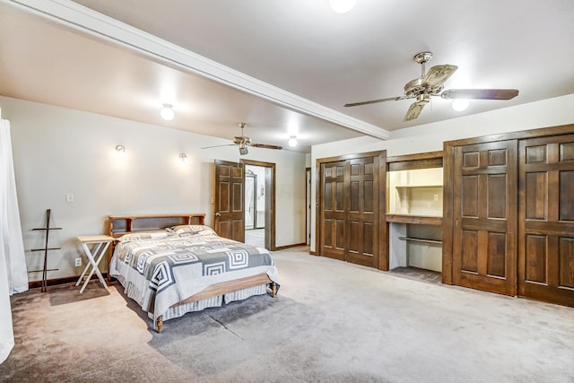 carpeted bedroom featuring beamed ceiling