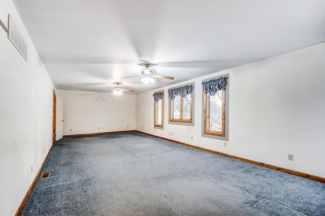 spare room featuring ceiling fan and dark colored carpet