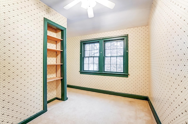 carpeted empty room with ceiling fan