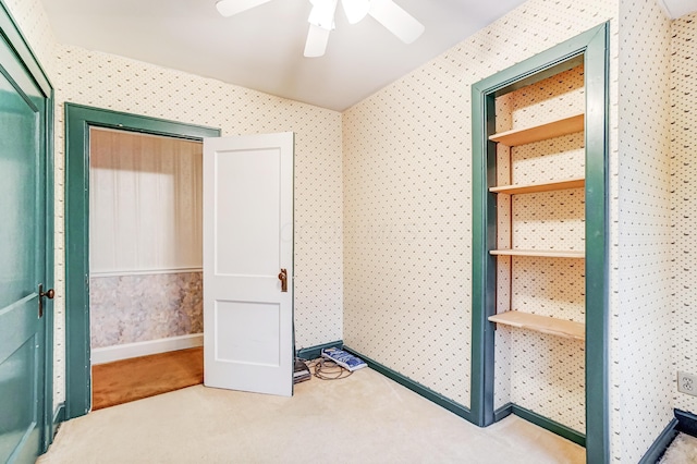 interior space featuring ceiling fan and carpet