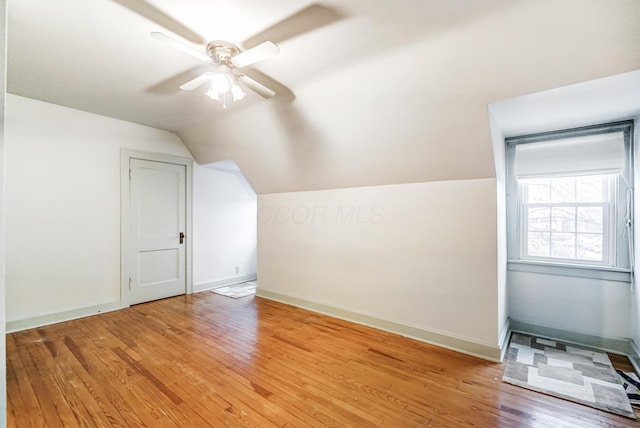 bonus room with vaulted ceiling, ceiling fan, and light wood-type flooring