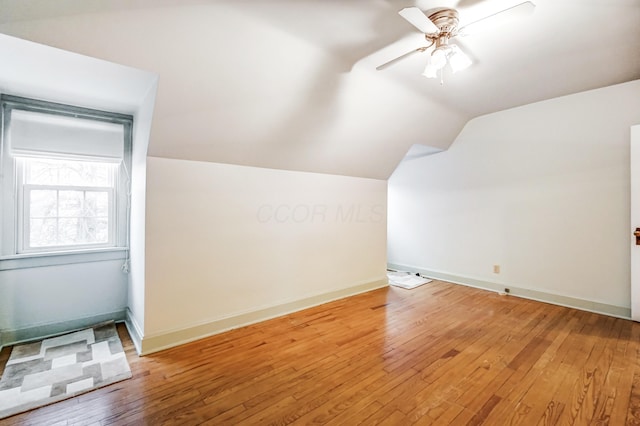 additional living space featuring lofted ceiling, hardwood / wood-style floors, and ceiling fan