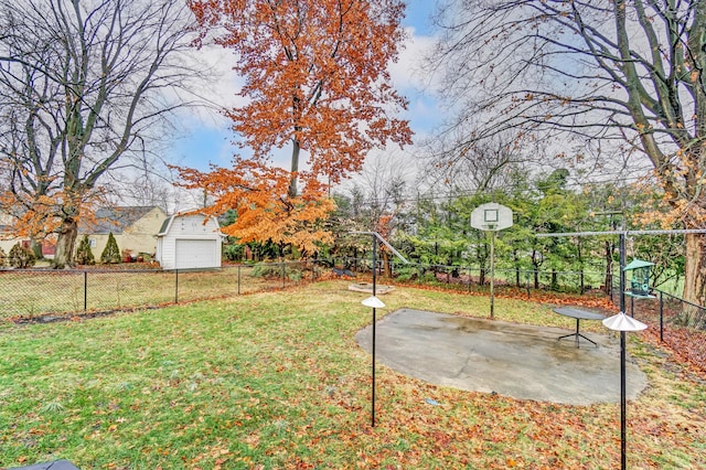 view of yard with basketball hoop, a playground, and a patio