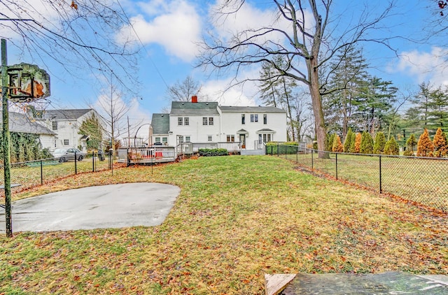 rear view of house featuring a lawn and a patio area