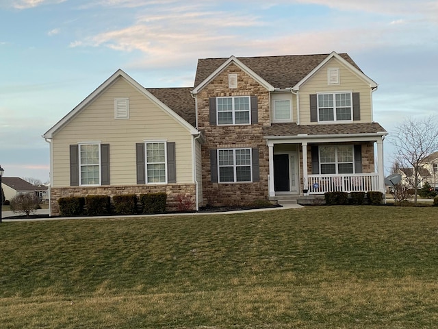 view of front facade featuring covered porch and a front lawn