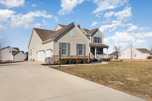 traditional-style house featuring stone siding, covered porch, driveway, and a front lawn