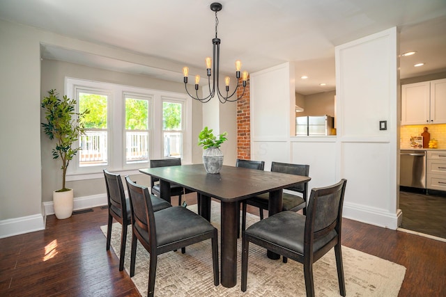 dining space featuring dark wood-type flooring and a chandelier