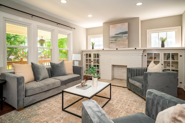 living room with a brick fireplace