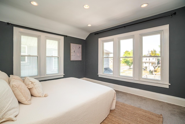 carpeted bedroom with vaulted ceiling