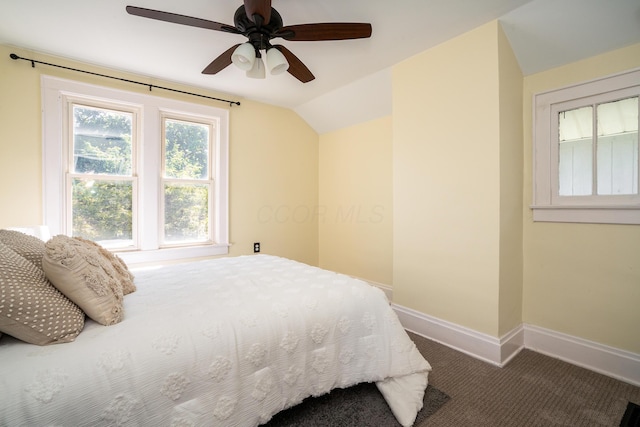 bedroom featuring dark carpet, ceiling fan, and vaulted ceiling