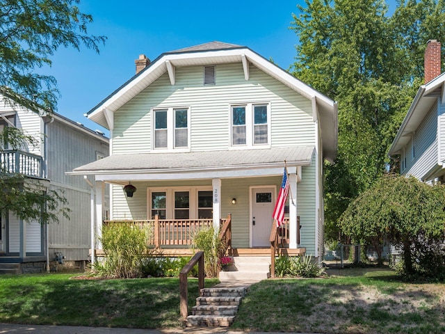 view of front of home featuring a front lawn and covered porch