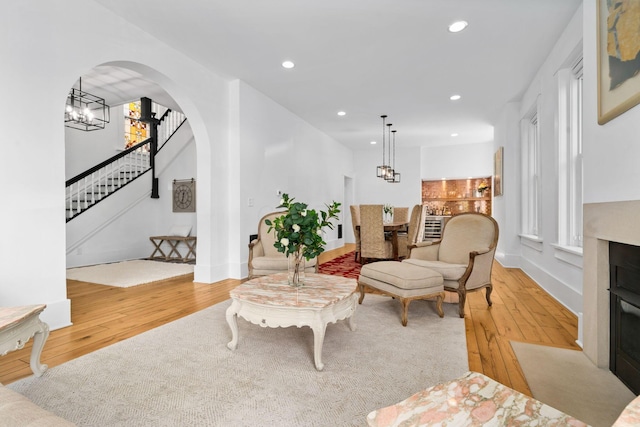 living room featuring a chandelier and light hardwood / wood-style flooring