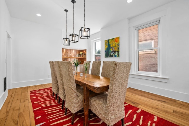 dining space with wood-type flooring