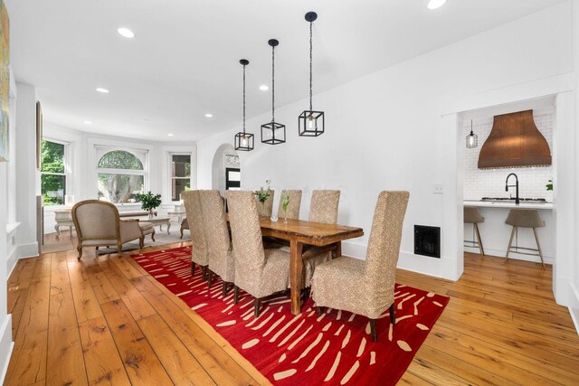 dining space with hardwood / wood-style flooring and sink