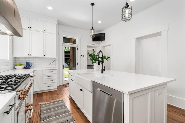 kitchen with decorative light fixtures, dishwasher, white cabinets, custom exhaust hood, and a kitchen island with sink