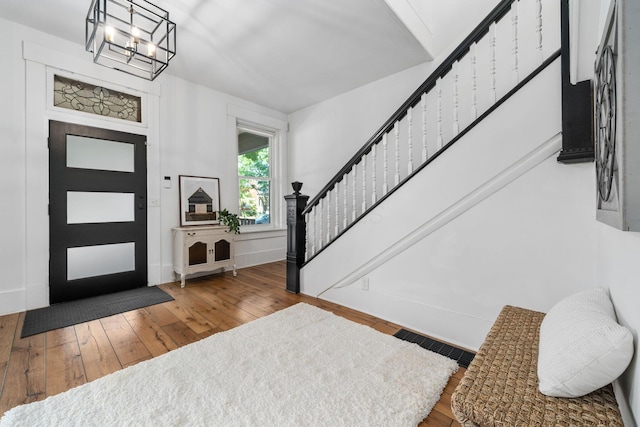 entryway with hardwood / wood-style flooring and an inviting chandelier