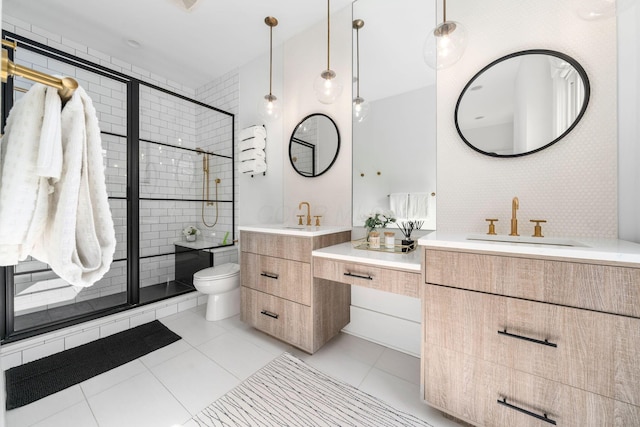 bathroom featuring tile patterned flooring, vanity, toilet, and walk in shower