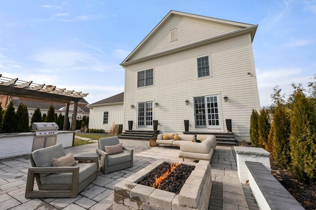 back of house featuring a pergola, a patio area, an outdoor living space with a fire pit, and french doors