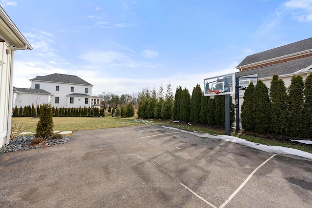 view of basketball court featuring a yard