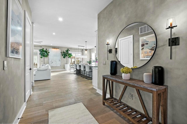 corridor featuring light hardwood / wood-style floors