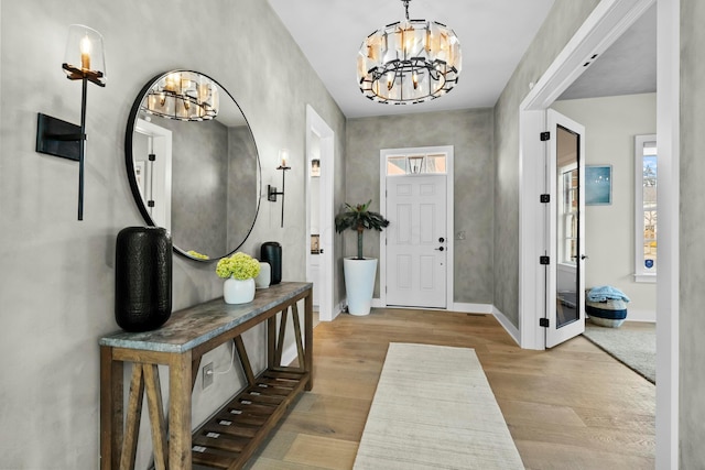 foyer featuring a notable chandelier and light hardwood / wood-style floors