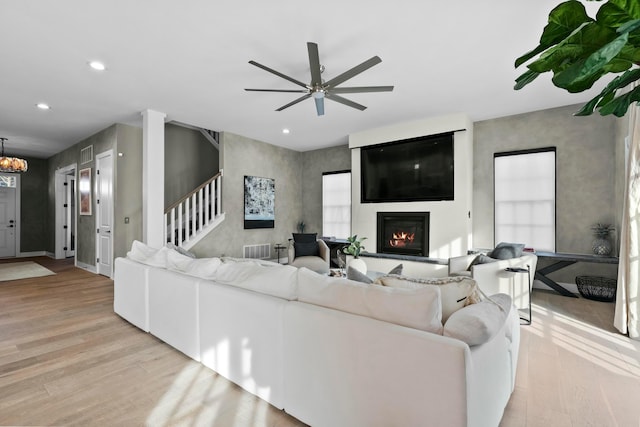 living room with ceiling fan and light hardwood / wood-style floors