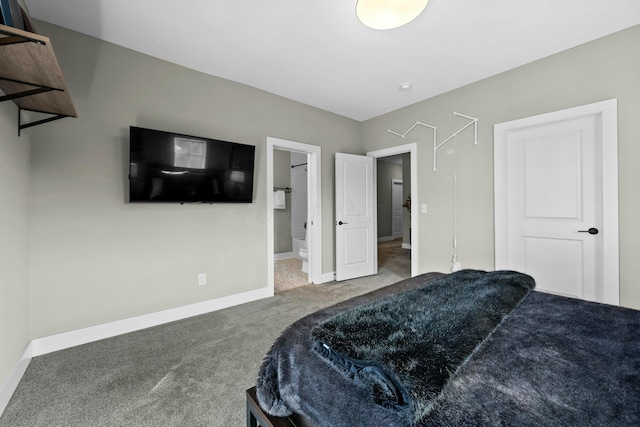 bedroom featuring ensuite bathroom and dark carpet