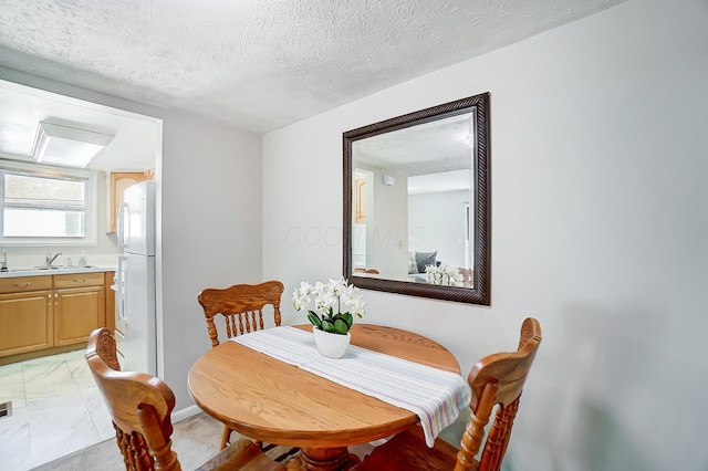 dining area with a textured ceiling