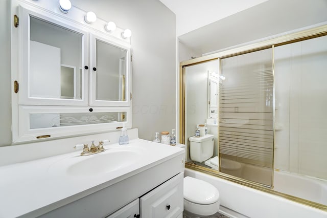 full bathroom featuring vanity, enclosed tub / shower combo, and toilet