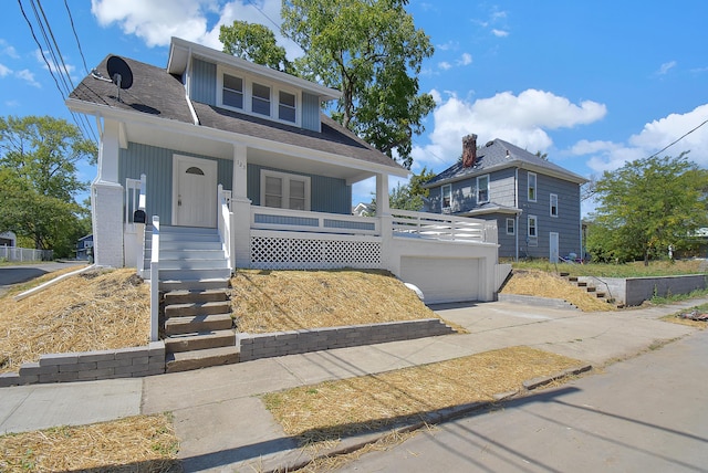 view of front property with a garage and covered porch