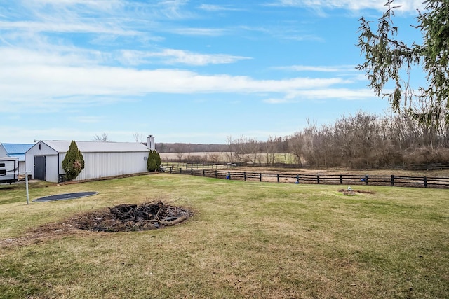 view of yard with an outbuilding and a rural view