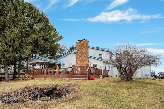 rear view of property featuring a wooden deck and a yard