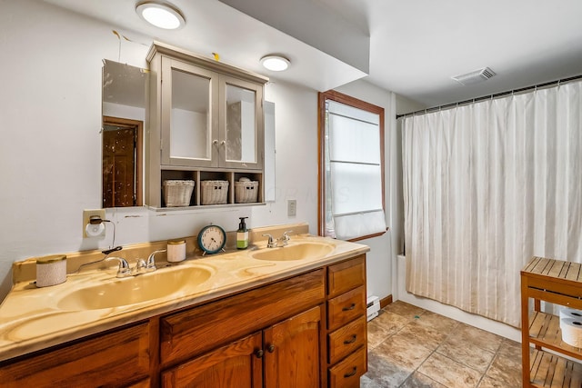 bathroom with tile patterned flooring, vanity, baseboard heating, and shower / bath combo with shower curtain