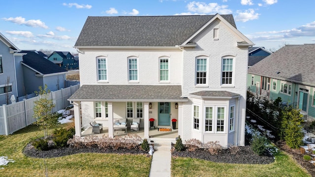 view of front of house with a patio and a front yard