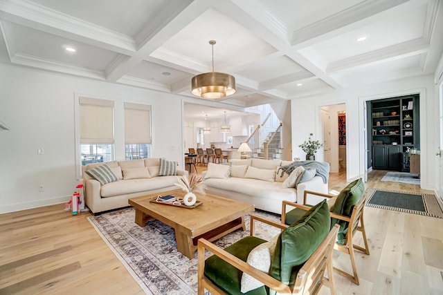 living room with coffered ceiling, beam ceiling, and light hardwood / wood-style flooring