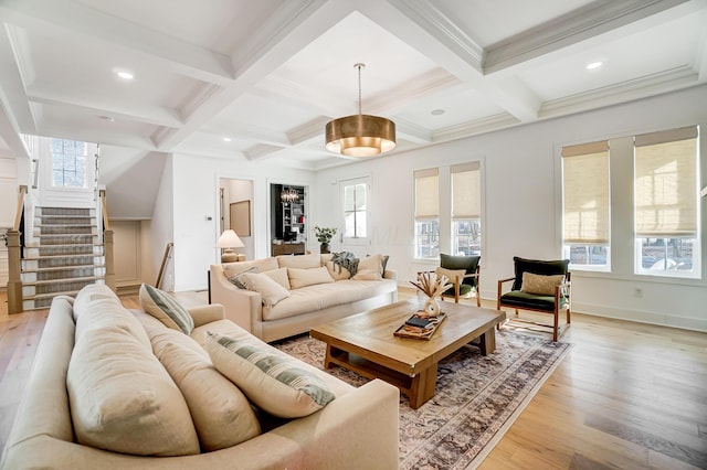 living room with beamed ceiling, ornamental molding, coffered ceiling, and light hardwood / wood-style floors