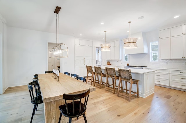 dining room featuring sink and light hardwood / wood-style floors