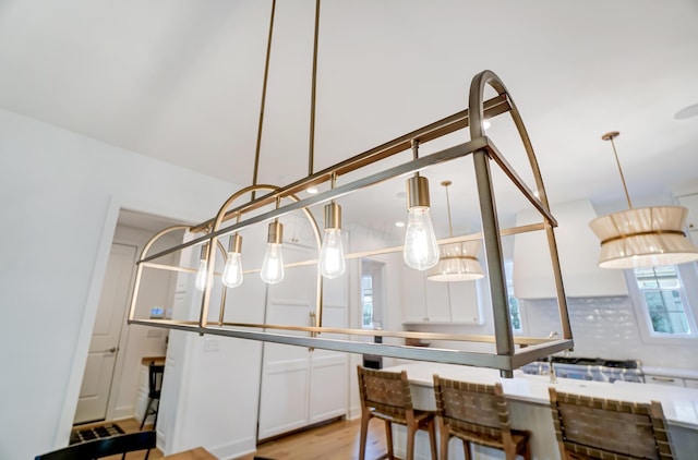 kitchen with white cabinets and light wood-type flooring