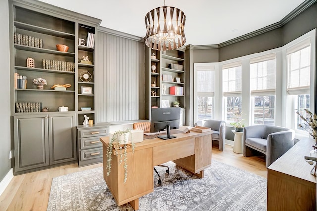 home office with crown molding, an inviting chandelier, and light hardwood / wood-style floors