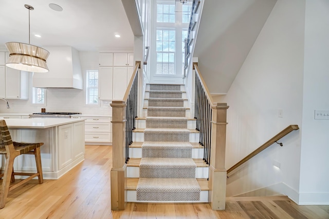 stairs with wood-type flooring