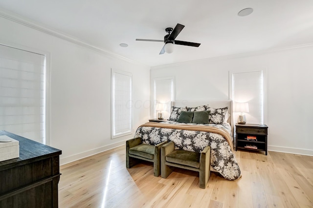 bedroom with ornamental molding, ceiling fan, and light hardwood / wood-style floors