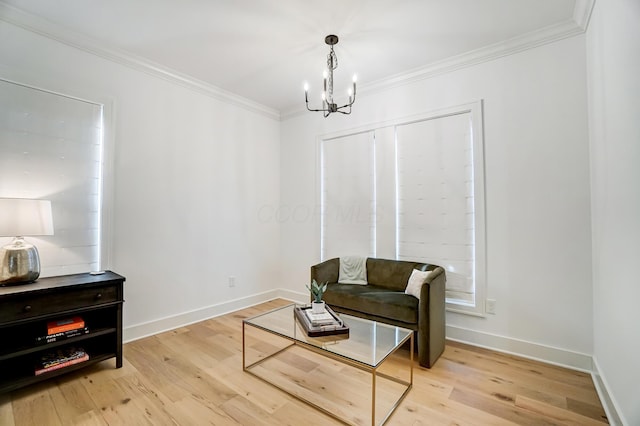 sitting room featuring an inviting chandelier, ornamental molding, and light hardwood / wood-style floors