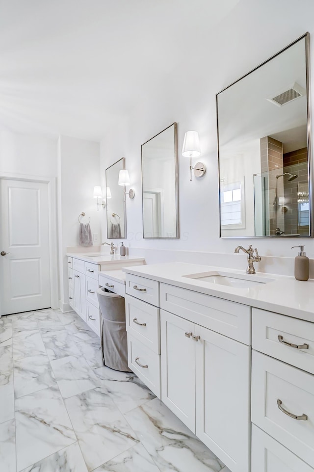 bathroom featuring vanity and a shower with door